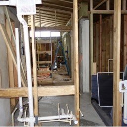 View of interior with framing and new plumbing after interior demolition